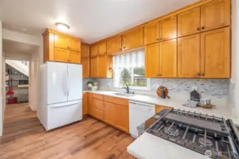 Extra tall ceilings = more cabinet space! New quartz counters & full tile backsplash add a beautiful touch