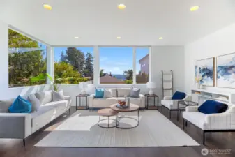 Huge windows shower the living room with light