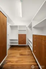 A wardrobe’s dream — spacious walk-in closet with gallery-like presentation for clothing, shoes, and accessories.