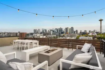 A rooftop lounge where city lights stretch endlessly — wine glasses clink as the skyline becomes your backdrop.
