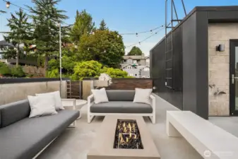 An intimate rooftop anchored by a modern firepit. The perfect gathering place for stories, laughter, and warmth.