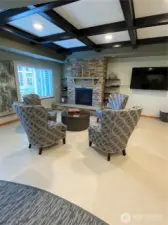 Natural gas fireplace seating area near entrance.