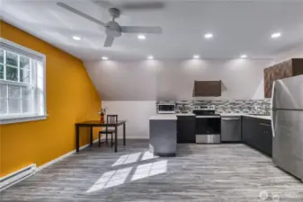 Bonus room above the garage with ceiling fan.