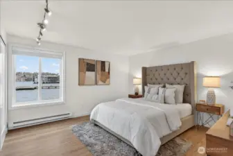 The primary bedroom is a serene lakeside retreat, featuring direct views of Lake Washington and David E. Brink Park pier right from your room. Warm floors, and a lake-view window create a calm, light-filled sanctuary — the perfect place to start and end every day.