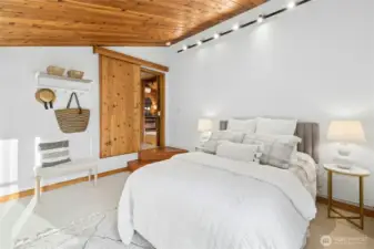 Moving over to the nicely-sized primary suite. A sunny room on the west side of the home with a fun barn door.