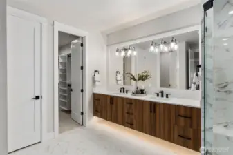 Primary Bedroom Bathroom has similar design, finishes, and color scheme as seen here, including the floating cabinet. (photo is a home recently built and sold by Builder)