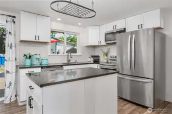 Kitchen has pot and pan hanger
