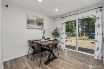 Dining room leads to the deck with an outdoor grilling station