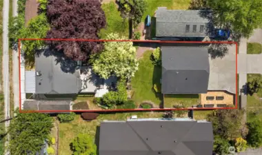 The back house lives privately with it's own fenced yard and the front DADU has a nice sized fenced side yard with a grass area and raised garden beds.