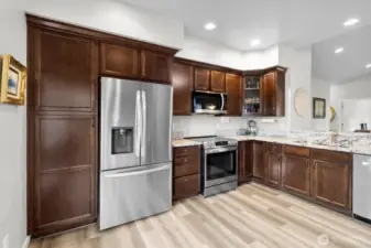 Stainless steel appliances in this open kitchen with large pantry and storage space.