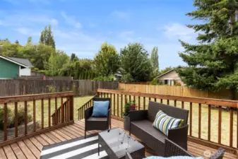 Sunny deck has room for your outdoor living furniture and grill. Steps down to your fenced and level yard.