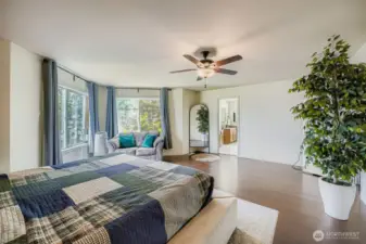 Large primary bedroom with tons of natural light