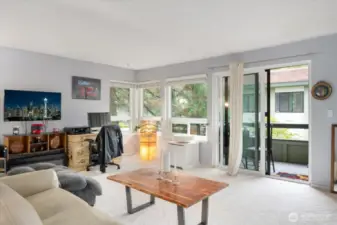 Light filled living room with views of mature landscaping. New carpeting!