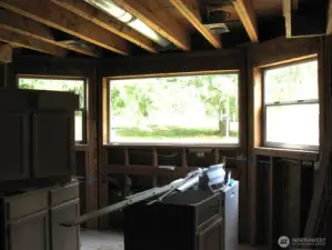 Kitchen area features a bay window looking out on the lushly, landscaped grounds