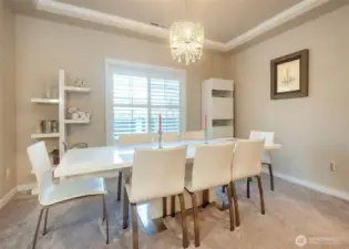 Formal dining space with crown molding.