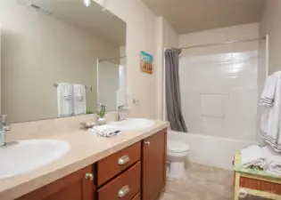 Main hall bathroom well appointed with two sinks.