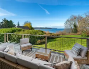 Spacious outdoor deck featuring comfortable seating and breathtaking water and territorial views.