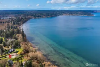 Aerial view capturing the home’s prime waterfront location and surrounding landscape.