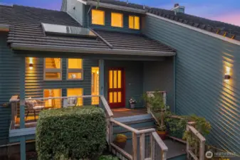 Evening exterior detail featuring welcoming entry and warm architectural accents.