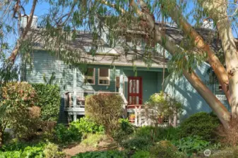 Charming exterior with mature landscaping and peaceful, private setting.