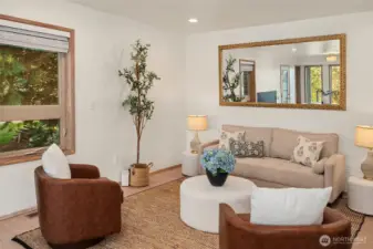 Bright living room with comfortable layout, natural light, and tasteful finishes.