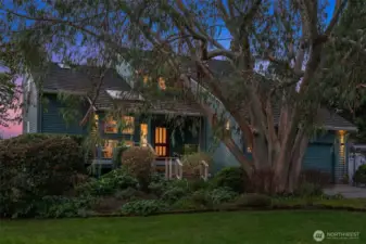 Exterior view highlighting mature trees, privacy, and tranquil island surroundings.