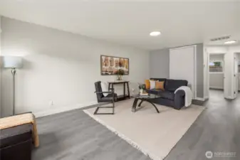 Living area with new plank flooring, fixtures, and paint