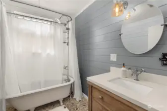 Remodeled primary bath with original clawfoot tub.