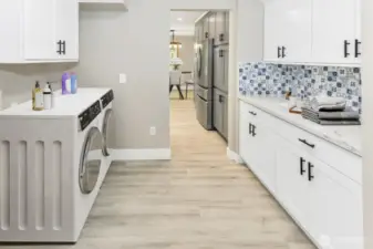 Virtually staged. Laundry room and prep kitchen off of the main kitchen.