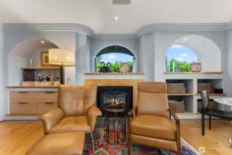 Custom built-ins w/ cozy gas indoor/ outdoor fireplace.