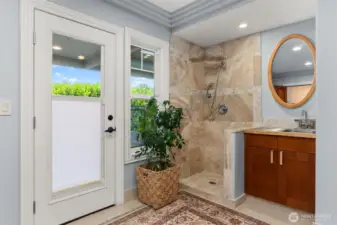 Door to North facing patio and garden beds. Shower for rinsing after swimming in the saltwater and or possible dog washing station.