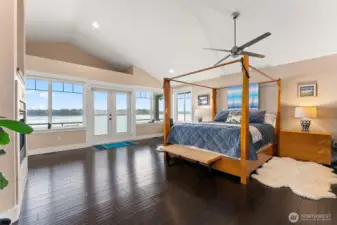 Primary Bedroom on the upper level in the North Tower. Vaulted ceilings, windows with sweeping views! Double sided gas fireplace and private balcony.