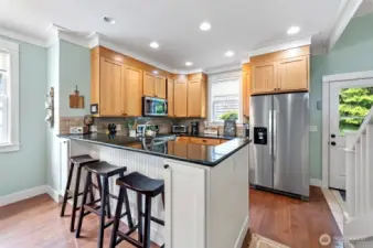 Stainless steel appliances, smart storage and additional seating in this hard working kitchen.