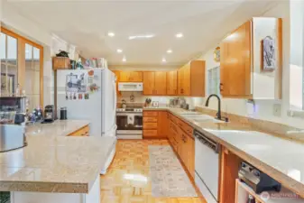 Kitchen with granite counters, oak flooring and oak cabinets