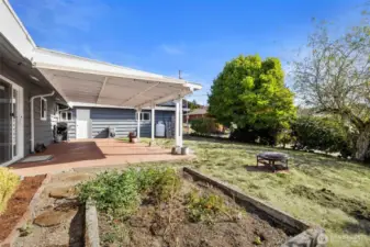 Spacious coverd patio, fenced yard and garden beds.