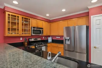 Large chef's kitchen with granite eating bar
