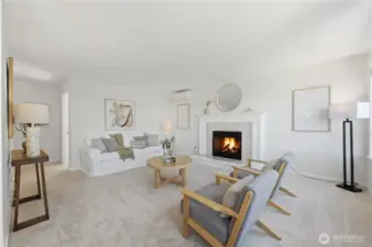 Gracious open living room with electric fireplace for ambience, freshly painted, new carpeting & mini split for ultimate heat & A/C comfort.