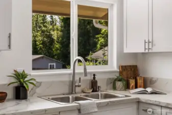 Sleek quartz counters with new soft close cabinets and new stainless steel appliances!