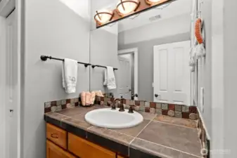 The Jack and Jill bathroom has two separate vanities.