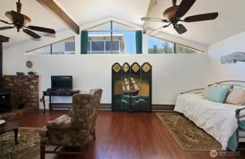Vaulted ceilings and windows above create an expansive space. Sellers have used this space as a second bedroom. There is no as built on file, however, the county has this home listed as a 2BR home on the Assessor docs. A door could be added to make this a spacious Primary Bedroom.