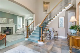Guests are welcomed by a stunning curved staircase, soaring 2-story entry, and an impressive blend of grandeur and warmth