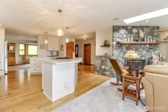 Natural light floods the space through a skylight, complementing the recessed lighting and enhancing the sophisticated ambiance. Plush carpeting adds comfort