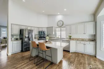 Updated kitchen with vaulted ceilings and tons of counter space (granite and quartz) /Stainless steel appliances