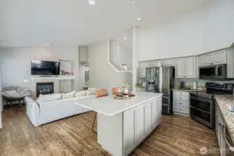 Open concept kitchen to living or dining area with gas fireplace