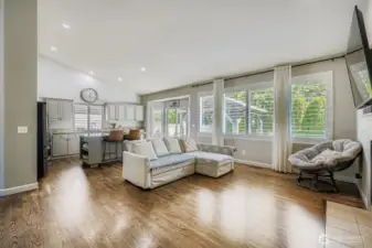Large open concept kitchen, living/dining with an abundance of natural light