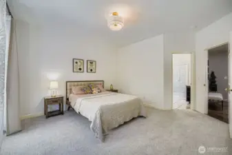 Spacious main floor primary bedroom leading to attached bathroom
