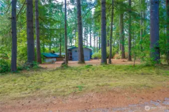 House set off the road, screened by stand of firs. 0ne plus acre flat lot...gorgeous property!