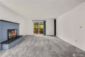 Living room, wood burning FP currently used for curio display. Deck overlooking property