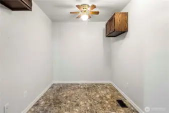 Spacious alcove off living room, great office spot! Approximately 12' X 7' with upper cabinets