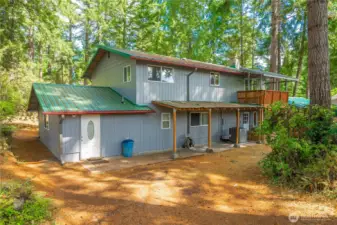 Backside of house, door to the left is exterior entry to studio apartment or secondary master suite, however space decided to be utilized.